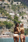 Beautiful carefree girl friends in bikini on beach sea lifestyle fun summer adventure vacation