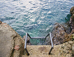 Ladder coming out of blue Mediterranean sea for swimming advenure possibility