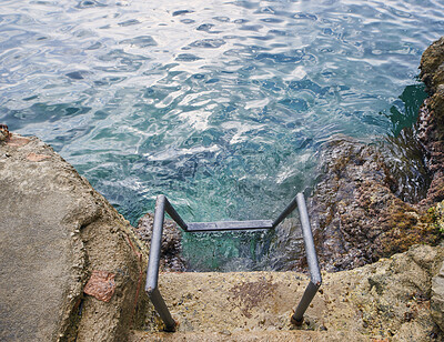 Buy stock photo Above, ladder and sea with calm, fresh air or tranquil environment for holiday, trip and vacation. Access, ocean water and ripples with outdoor background of nature for getaway, space or travel