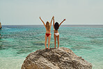 Adventure beautiful friends arms raised on paradise beach on destination summer wanderlust vacation 