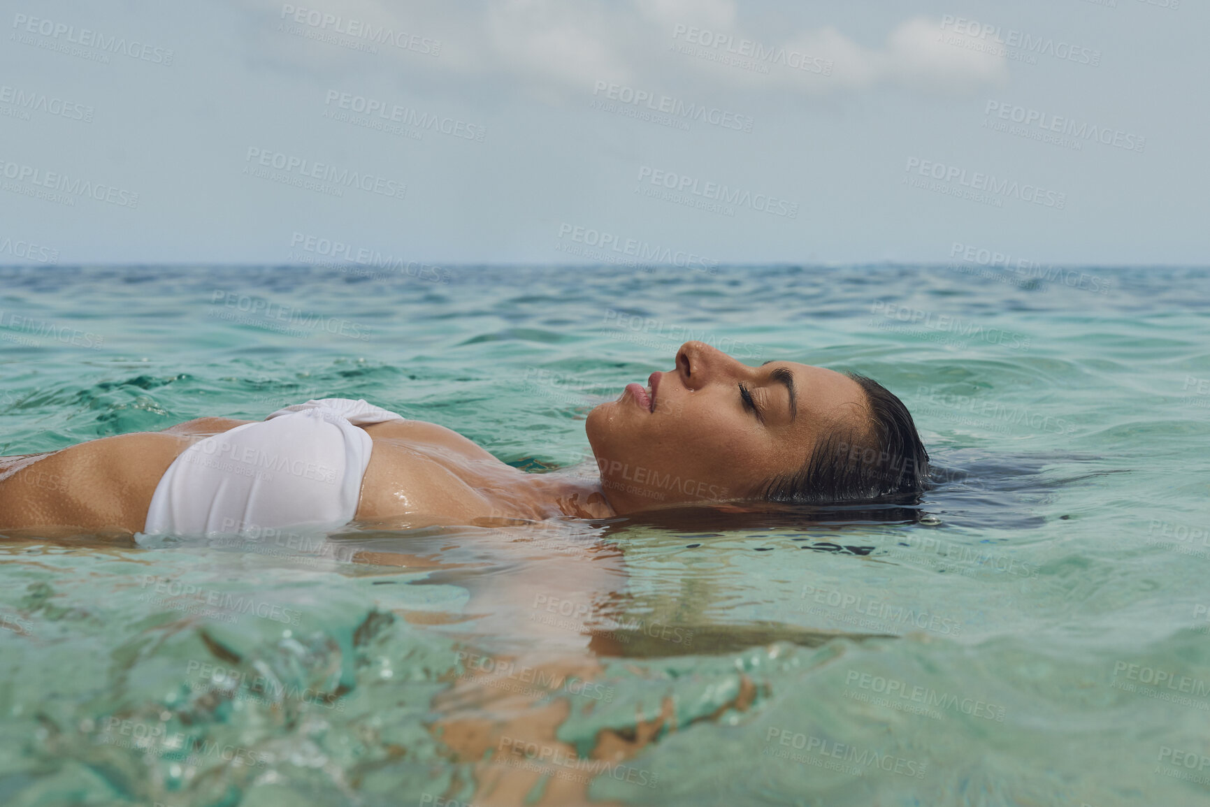 Buy stock photo Woman, floating and relax in water on beach for outdoor holiday, weekend or vacation in nature. Calm, female person or travel in sea for peaceful adventure, break or rest in ocean for summer getaway
