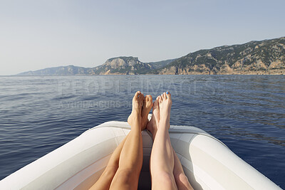 Buy stock photo Women, legs and lying with boat on sea for outdoor adventure, travel or sightseeing together. Relax, female people or feet on ocean water or beach with island view for natural scenery in nature