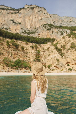Buy stock photo Woman, travel and sea with hat in nature for summer vacation, journey or outdoor adventure. Back view, female person or traveler with natural scenery on boat, ocean water or beach for sightseeing