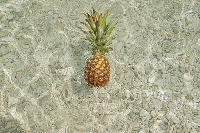 Buy stock photo Pineapple, ocean and food with tropical fruit on beach for summer diet or health in nature. Empty, space and organic immune booster with waves in sea water for vitamin C, antioxidant or paradise