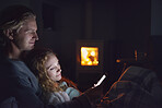 Happy man woman couple using smart phone technology cosy at home by fire connection network romance