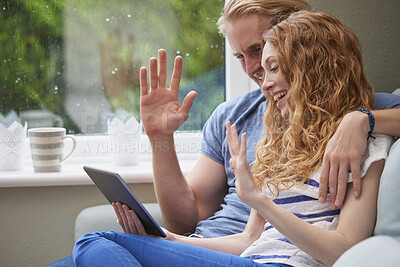 Buy stock photo Happy, couple and wave with tablet in home for video call, hello or communication on sofa. Man, woman or relax with smile, technology or app for virtual chat, conversation or discussion in house