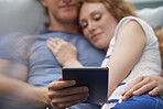 Attractive happy couple using digital computer tablet connected internet social media at home