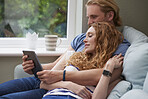Attractive happy couple using digital computer tablet connected internet social media at home