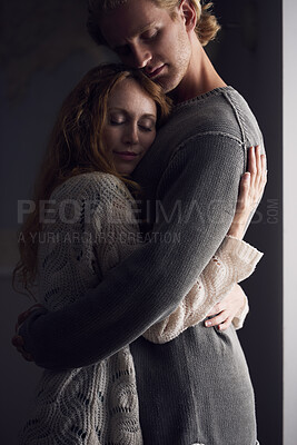 Buy stock photo Embrace, love and safety with couple in home together for emotional support or relationship security. Calm, happy or trust with man and woman hugging in apartment for bonding or wellness at night
