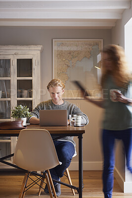 Buy stock photo Laptop, morning and remote work with man in home for planning, research or small business. Computer, motion blur and startup career with couple of people in apartment together for freelance job