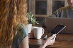 Attractive man woman couple using laptop digital tablet technology at home browsing internet network