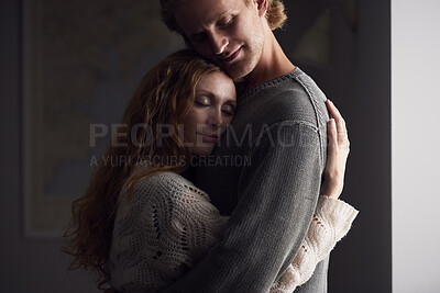 Buy stock photo Hug, love and security with couple in home together for emotional support or relationship trust. Calm, happy or safety with man and woman embracing in apartment for bonding or wellness at night