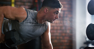 Buy stock photo Fitness, weight training or athlete in center with dumbbell, power or renegade row in bodybuilding. Exercise, sweat or man in gym with equipment, intense workout or strength in muscle development.
