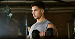 Fitness, serious and man with weights in gym, strength challenge and routine for muscle development. Bodybuilding, bicep training and athlete with dumbbell in sports club, strong and intense exercise