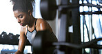 Fitness, exhausted and woman in gym, thinking or rest with intense training recovery for bodybuilder. Break, sweating and tired African person in exercise club for health, reflection and challenge
