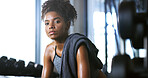 Portrait, tired and woman in gym for fitness break, wellness and recovery from body building exercise. Serious, athlete and person in health club for muscle rest, confidence and fatigue for challenge