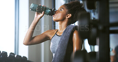 Buy stock photo Woman, fitness and drinking water in gym with break, sweating or training recovery for wellness. Active, African person and cardio exercise in health club for hydration, electrolytes or h2o nutrition