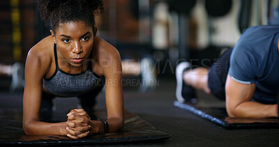 Buy stock photo Woman, people and plank in gym with workout, strength training and control breathing for wellness. Serious, person and balance on floor with stability, fitness challenge and exercise class for abs.
