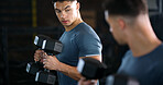 Exercise, mirror and weightlifting with man in gym for routine, strength training or workout. Dumbbells, fitness and reflection with person in health club for activity, challenge or progress