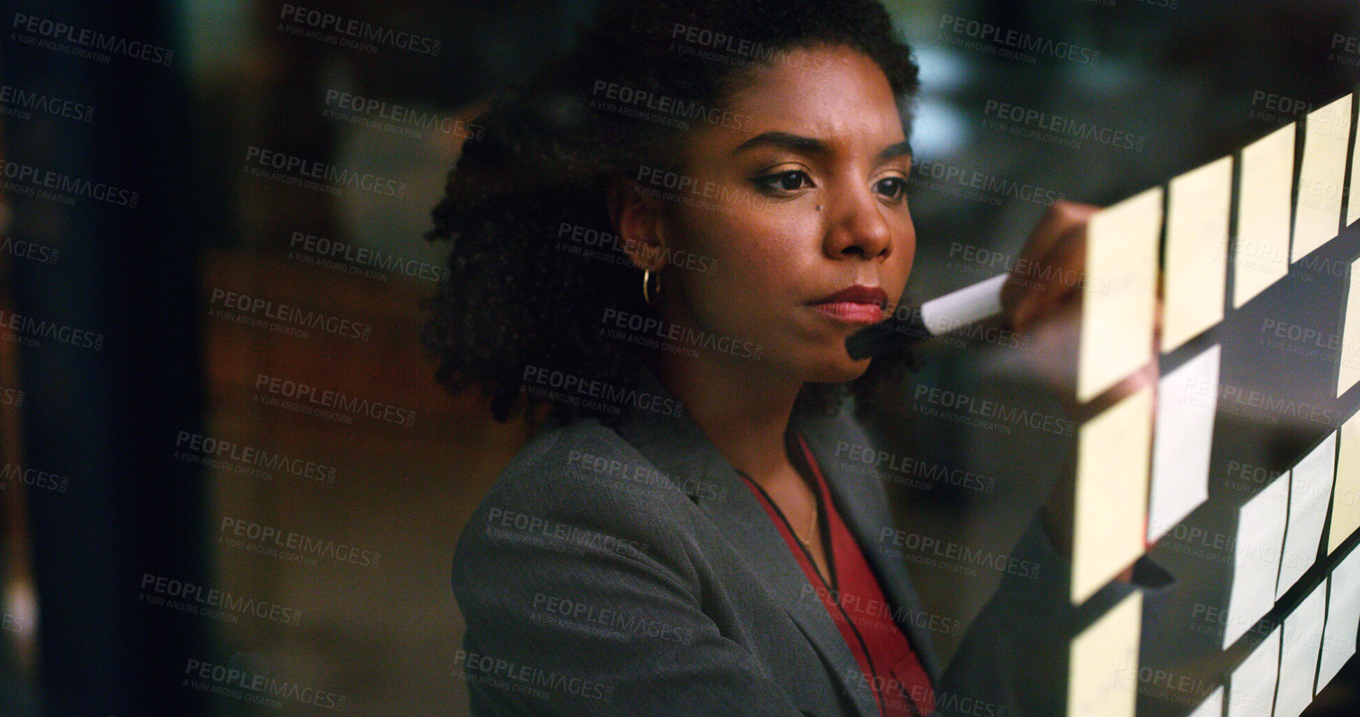 Buy stock photo Night, businesswoman and writing on glass with sticky note, brainstorming and plan for audit deadline. Space, auditor or black person work late in office with strategy, problem solving or objectives.