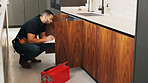 Inspection, plumber and man with clipboard in kitchen for pipeline maintenance or valve corrosion. Checklist, evaluation or handyman with leak report in home for filter system installation or repair