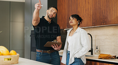 Buy stock photo Checklist, discussion and handyman with woman in kitchen for maintenance, service or home renovation. Installation, inspection or man with clipboard for client information, pointing or invoice