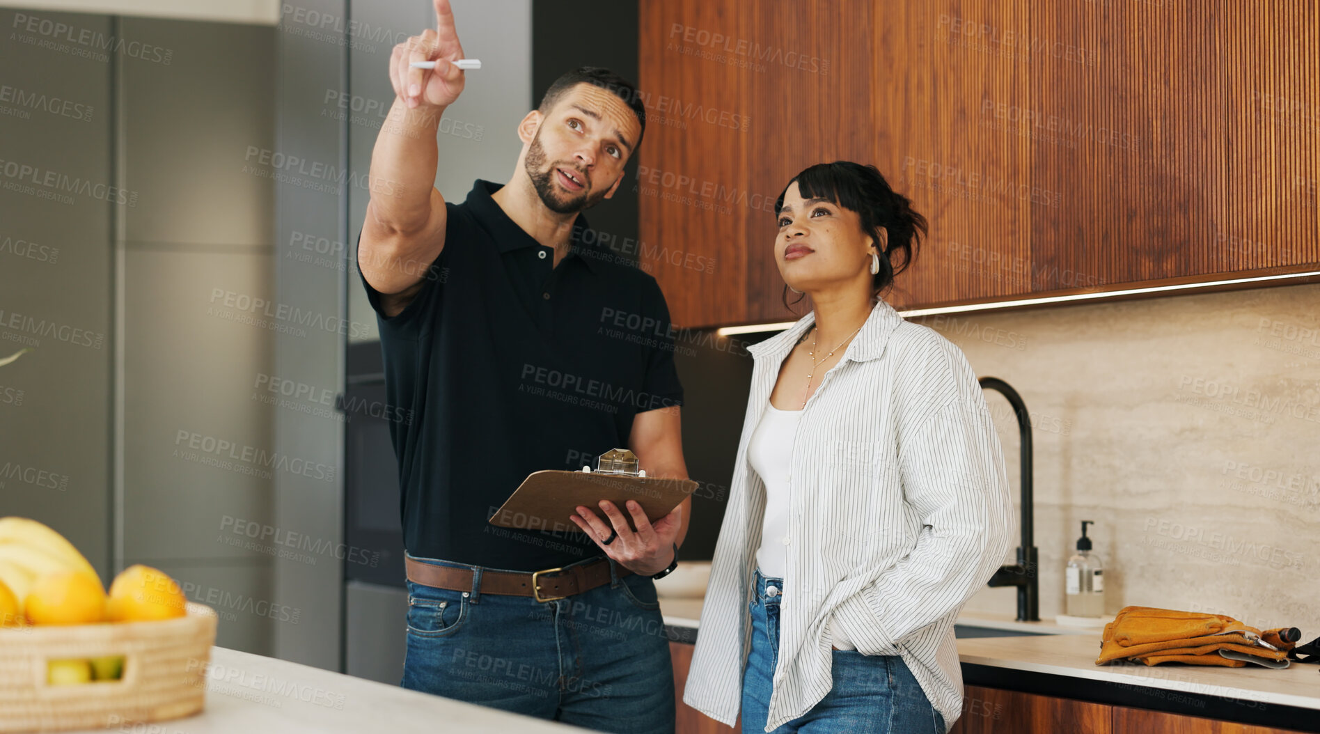 Buy stock photo Checklist, discussion and handyman with woman in kitchen for maintenance, service or home renovation. Installation, inspection or man with clipboard for client information, pointing or invoice