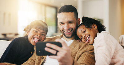 Buy stock photo Father, children and tongue out in home with selfie, bonding together and social media post on weekend. Dad, girl kids and funny face in living room with photography, memories and family connection.