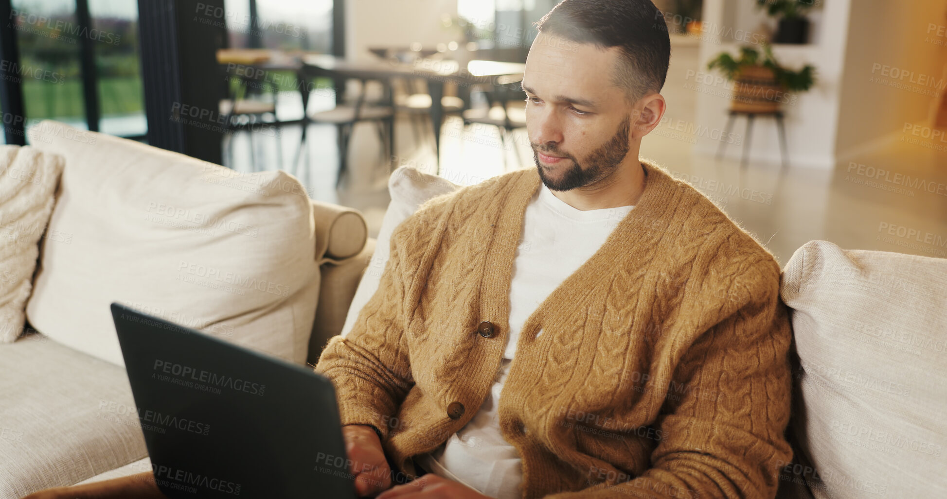 Buy stock photo Freelancer, laptop and man in home for research, digital marketing or reading email in living room. Computer, remote work and person on sofa for campaign project, brand proposal and review ads