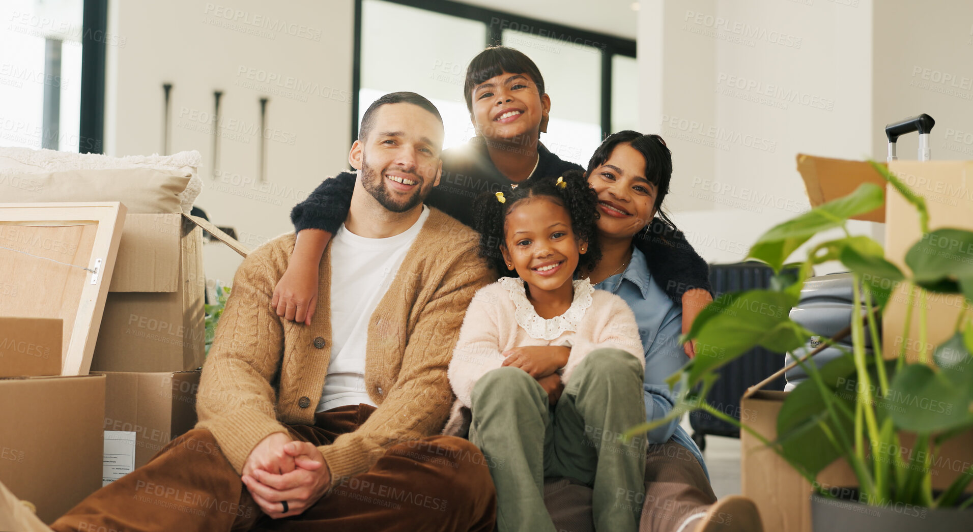 Buy stock photo Portrait, parents and moving in new home with children, package and smile for property investment. Happy people, mother and father in house with girl kids, boxes and family bonding for relocation.