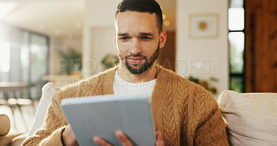 Buy stock photo Tablet, relax and man in apartment for reading ebook, online search and entertainment on sofa. Tech, smile and person at home for social media profile, browsing internet or news with daily update