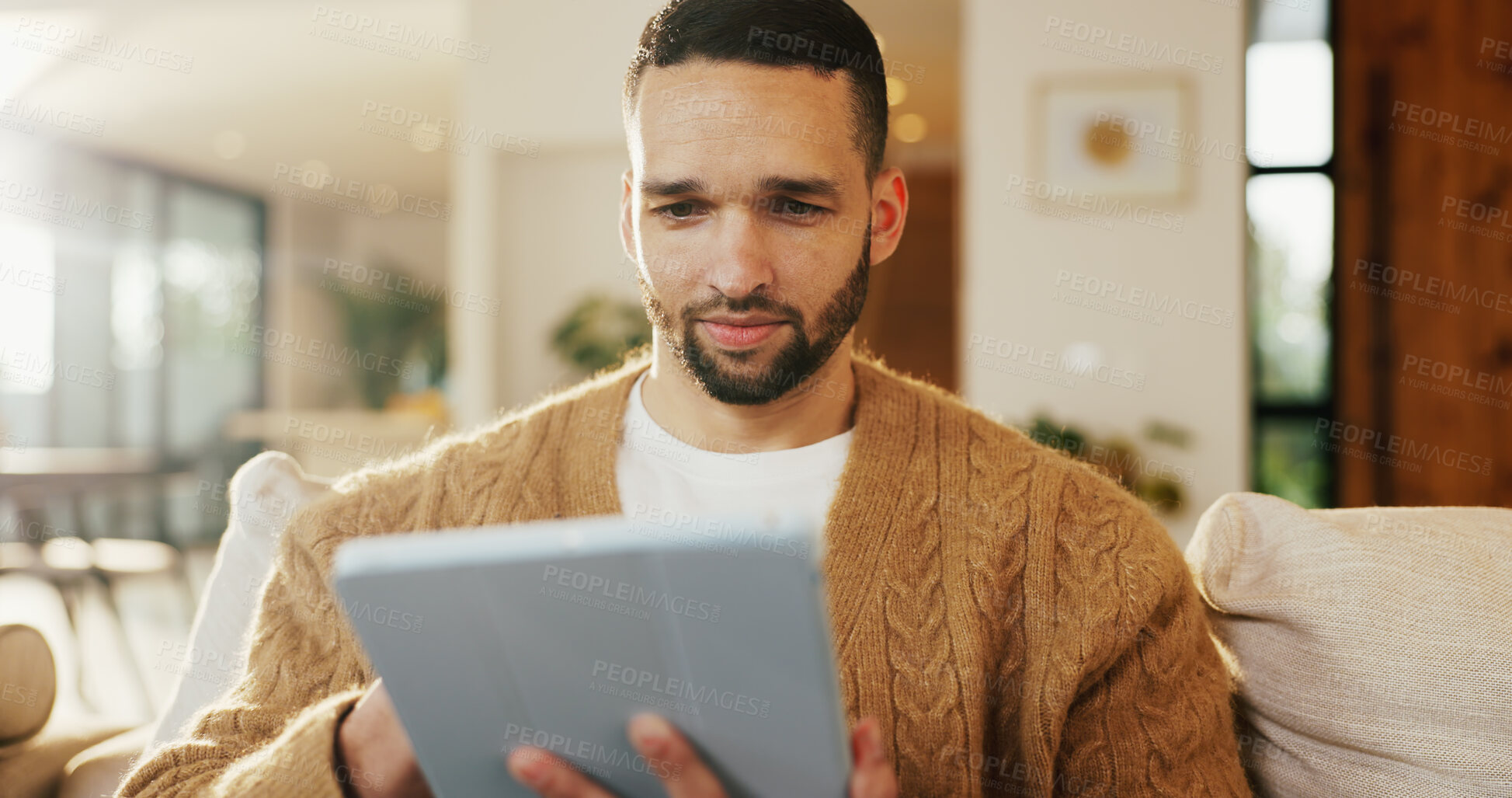 Buy stock photo Tablet, relax and man in apartment for reading ebook, online search and entertainment on sofa. Tech, smile and person at home for social media profile, browsing internet or news with daily update