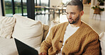 Freelancer, laptop and man in home for email, digital marketing or reading research in living room. Computer, remote work and person on sofa for campaign project, brand proposal and review ads