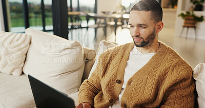 Buy stock photo Freelancer, laptop and man in home for email, digital marketing or reading research in living room. Computer, remote work and person on sofa for campaign project, brand proposal and review ads