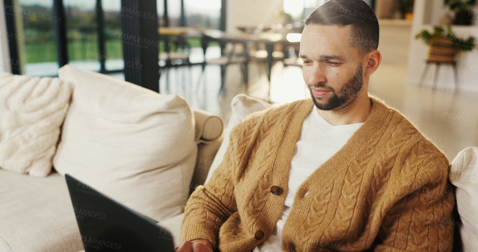 Buy stock photo Freelancer, laptop and man in home for email, digital marketing or reading research in living room. Computer, remote work and person on sofa for campaign project, brand proposal and review ads