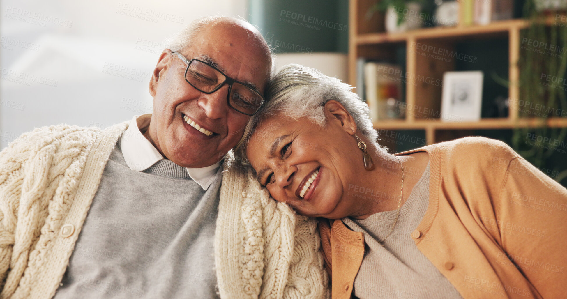 Buy stock photo Old couple, love and hug with smile in house, retirement and care with partner on weekend in lounge. Elderly people, embrace and comfortable with spouse, romance and happy for affection in home