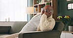Tired, sleeping and senior man in living room with rest, glasses and peaceful retirement in nursing home. Elderly person, fatigue and relax on couch wellness, calm or afternoon nap for stress relief.