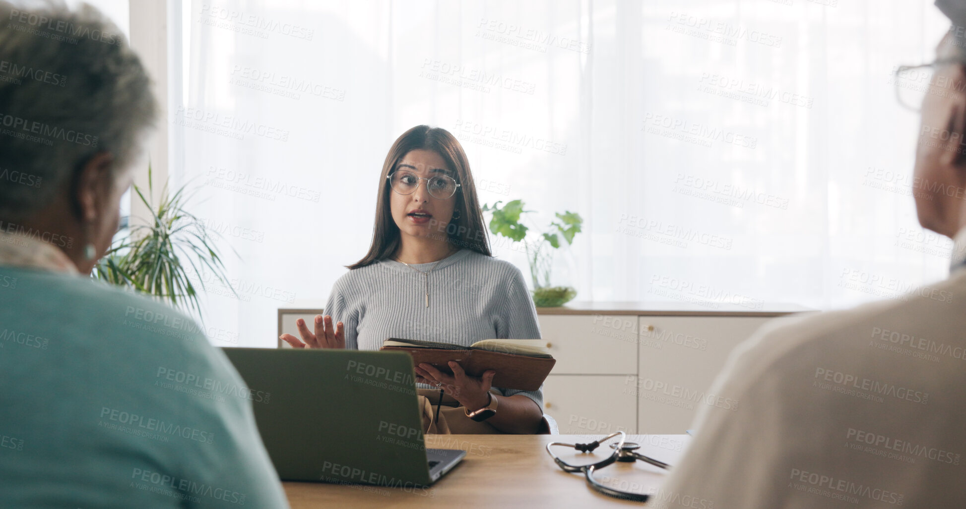Buy stock photo Doctor, consultation and old couple in office with advice, notebook and laptop for medical diagnosis. Healthcare worker, senior married people and talk in meeting with diary, research or test results