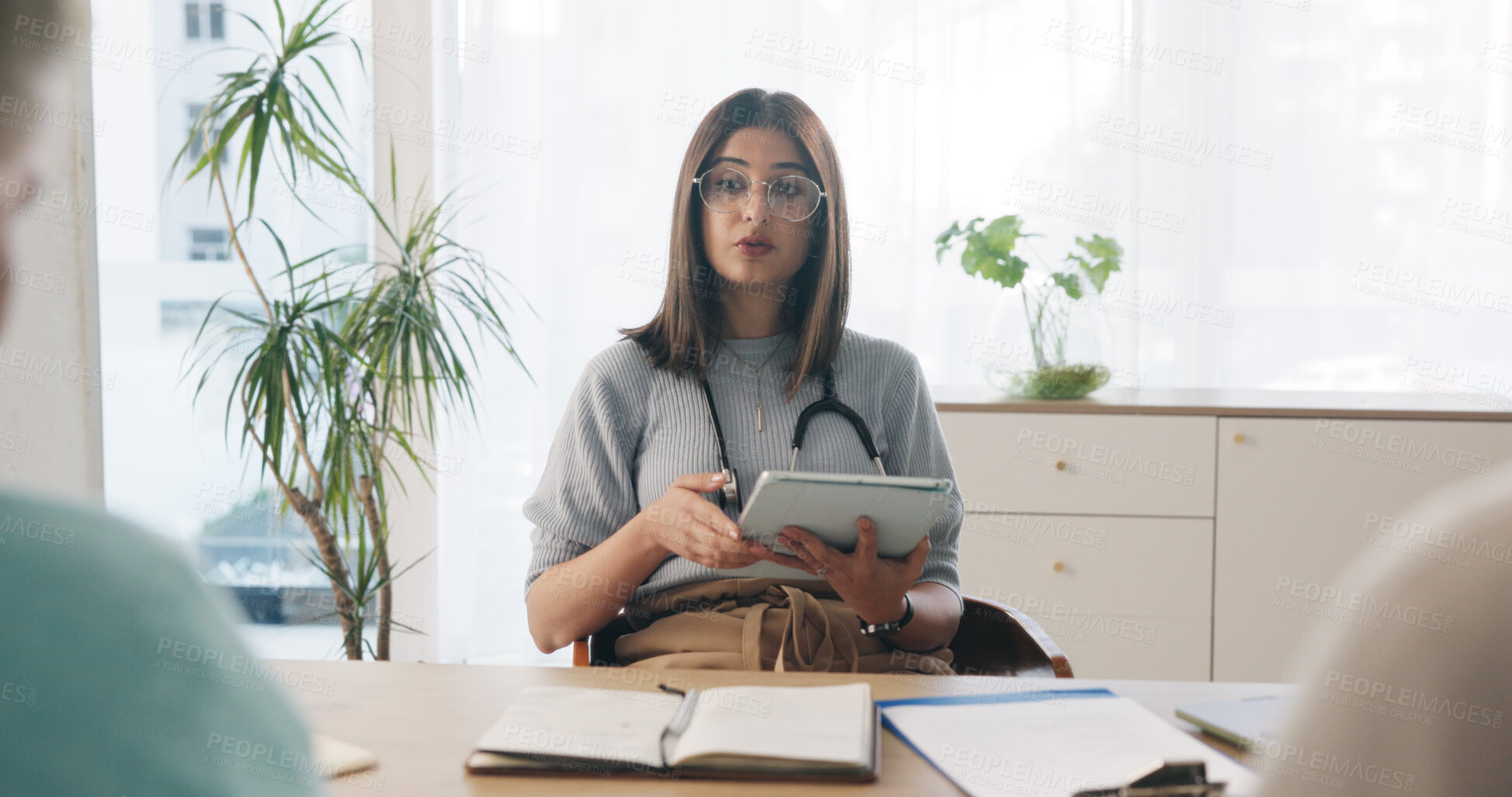 Buy stock photo Doctor, discussion and people in consultation with tablet, advice and research for medical diagnosis. Healthcare worker, patient and conversation in office with tech, help and test results feedback.