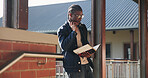 Headphones, reading and black man with book at university for education, learning and review for test. Scholarship, student and study notes with paper at campus for exam, information and knowledge