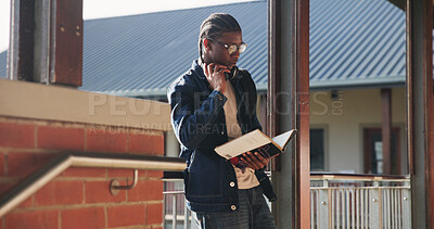 Buy stock photo Headphones, reading and black man with book at university for education, learning and review for test. Scholarship, student and study notes with paper at campus for exam, information and knowledge