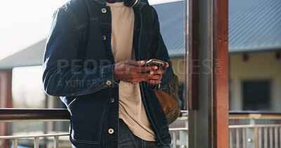 Buy stock photo Education, hands and phone with student on university campus for communication or development. App, learning and typing text message with man at college for internet or social media browsing