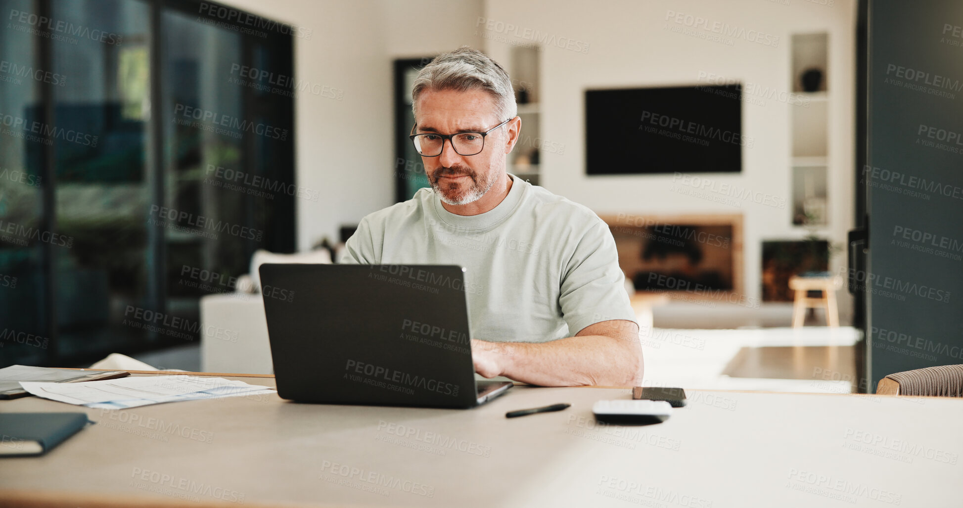 Buy stock photo Mature, man or laptop with documents in home for financial planning, budget or report. Male person, accounting or audit with technology, invoices or calculator for finance, expenses or bills in house