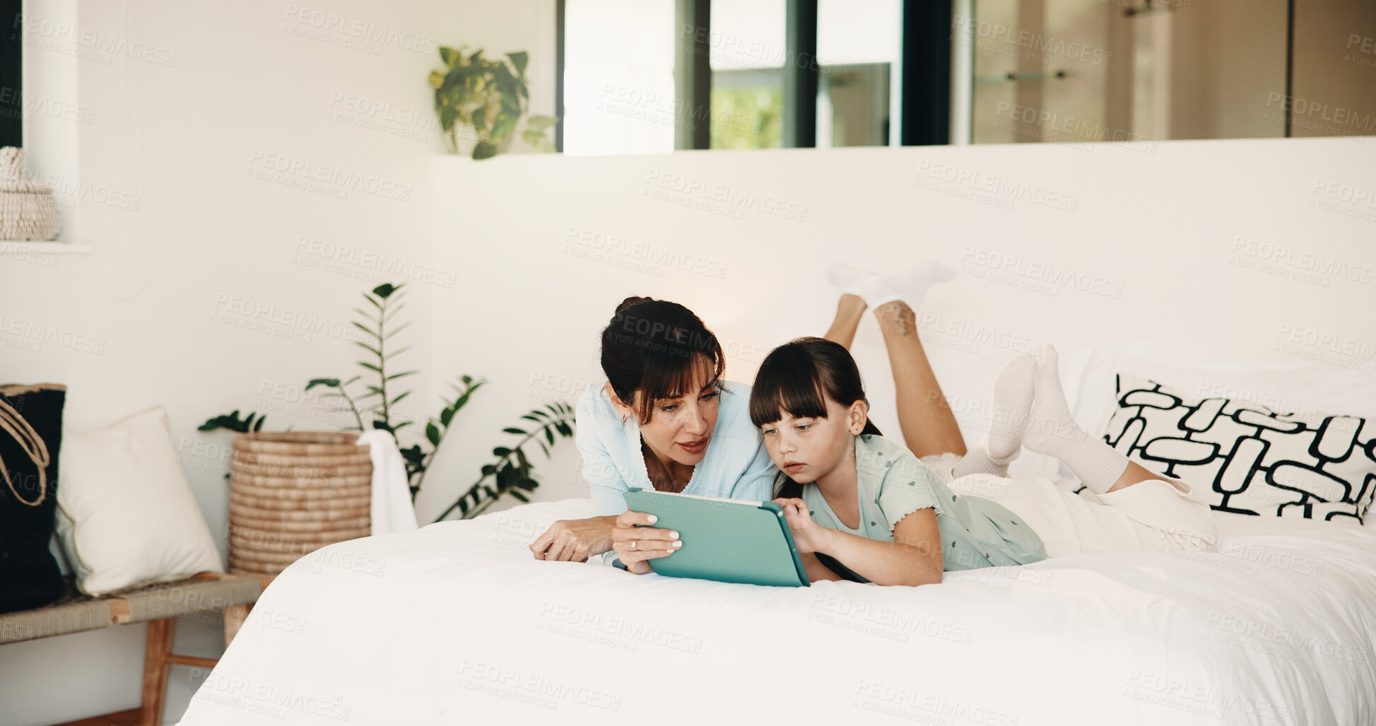 Buy stock photo Mother, daughter and talk in bedroom with tablet, website and play knowledge game for development. Happy family, mom and child typing in home with tech, learning app or educational gaming for growth.