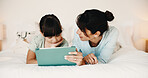 Mother, daughter and reading in bedroom with tablet, ebook and online literature for knowledge growth. Happy family, mom and child in home with tech, storytelling app and learning for development.