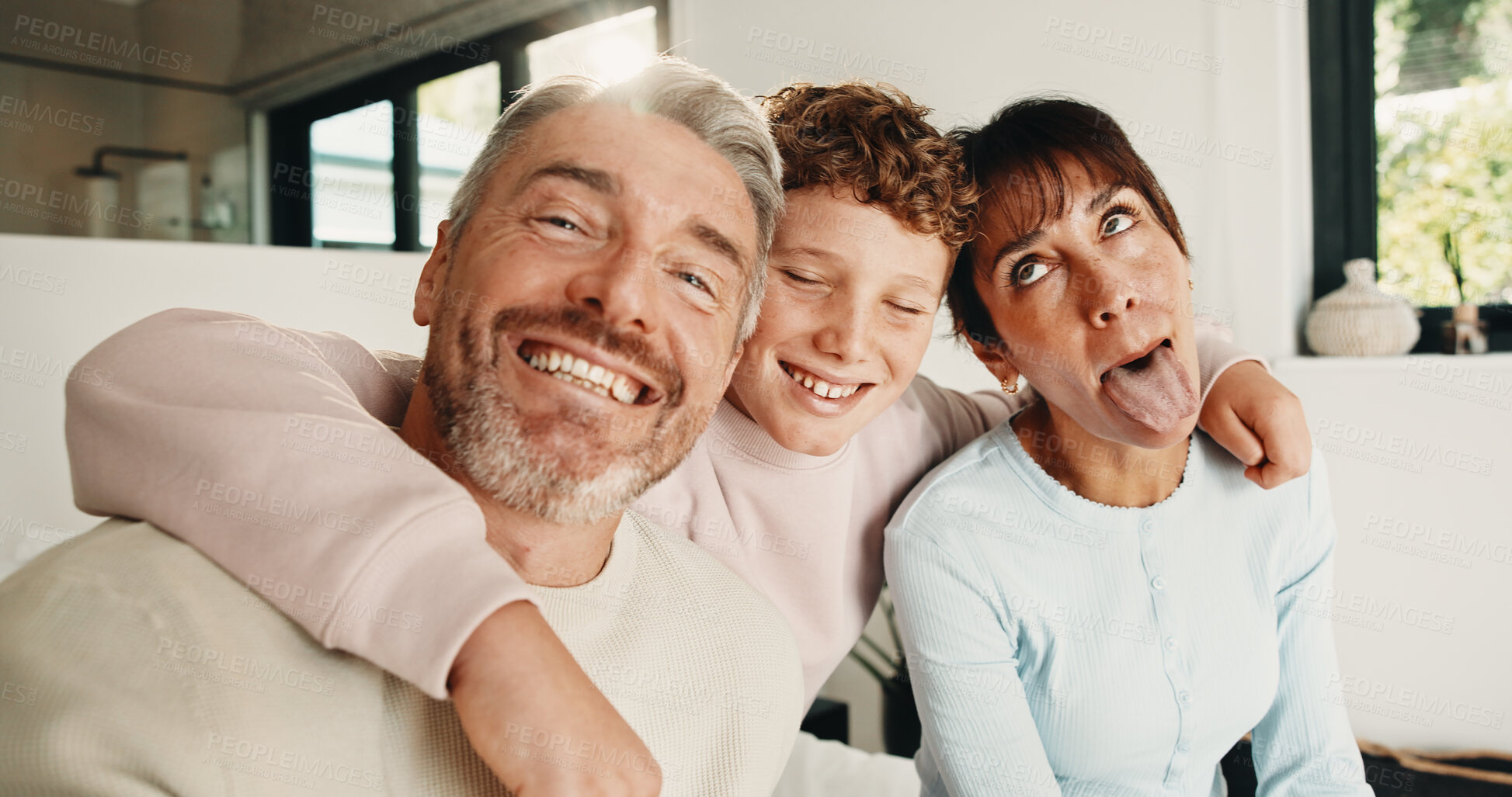 Buy stock photo Family, hug and love in home, funny face or connection together on weekend break with child. Mother, father and kid at house for care, portrait and embrace parents for support with silly memory