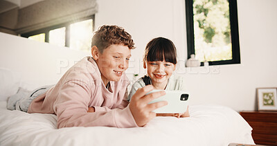 Buy stock photo Relax, brother or sister with phone in bedroom, watch cartoon or streaming movie for siblings bonding. Film subscription, internet and children with mobile for video platform, smile and rest in home