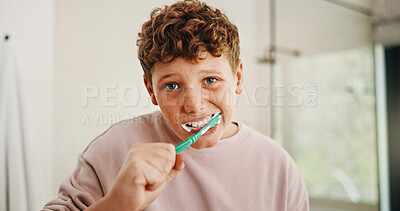 Buy stock photo Toothbrush, dental health and portrait of kid in bathroom for development, growth or hygiene in home. Toothpaste, wellness and boy child brushing teeth in morning for plaque removal and oral care.