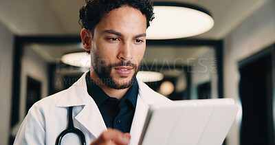 Buy stock photo Medical, tablet and doctor with online results, research or healthcare app for telehealth report. Tech, hospital and man with problem solving, reading or analysis of clinical test in hallway