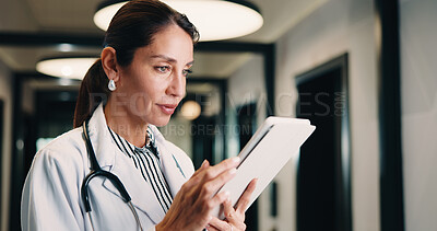 Buy stock photo Hospital, tablet and doctor with digital records, schedule or healthcare app for research. Clinic, tech and physician woman with telehealth report, review or reading of online results in hallway